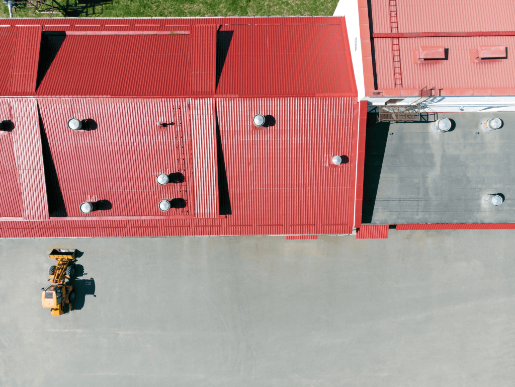 roof of an industrial warehouse coated in red paint and thermal coat